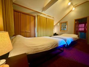 a bedroom with two beds and a window at Five room 120 SKY TREE SENSOJI FreeParking 1292sqft in Tokyo