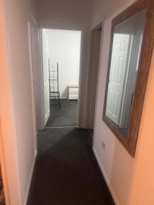 a hallway with a mirror and a chair in a room at Nobles Nest in Skegness