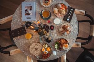 a table with a bunch of breakfast foods on it at Quality Hotel Ålesund in Ålesund