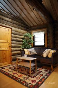 a living room with a couch and a table at Holiday Home Hopukka F12 in Luosto +1 photo