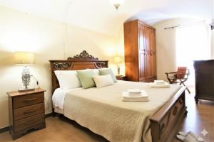a bedroom with a large bed and a dresser at da Patrick in Costarainera