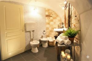 a bathroom with a toilet and a sink at da Patrick in Costarainera +14 photos