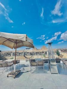 a patio with tables and chairs and an umbrella at Pyramids Fort & free pickup shuttle in Cairo +62 photos