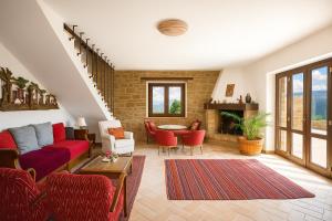 a living room with red furniture and a fireplace at VILLA ERMELINDA - Ville Carborello in Castelraimondo