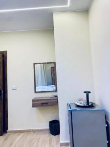 a room with a mirror on the wall and a refrigerator at Pyramids Fort & free pickup shuttle in Cairo