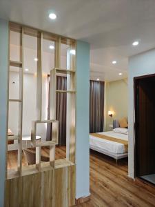 a bedroom with a bed and a room with a television at Tathastu Stay in Dehradun