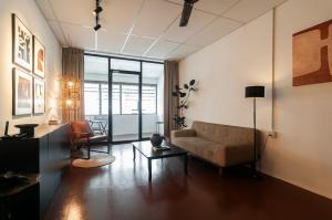 a living room with a couch and a table at Aayu Church St - 7 mins to Esplanade, George Town in George Town