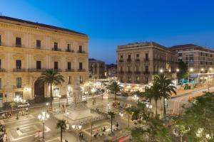 a view of a city street at night at Belduomo Catania Rooms & Flat in Catania