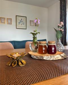 a table with two jars of honey and flowers on it at Mystic Twistic in Vîrfurile