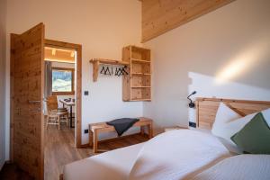a bedroom with a bed and a table and a window at S'Mitterer in Itter