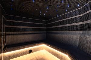 a room with a bath tub with lights in it at Hotel Alpin in Szczyrk +35 photos