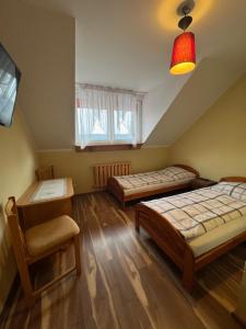 Postel nebo postele na pokoji v ubytování Zajazd Oleńka