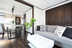 a living room with a couch and a table at Corp F Haneda in Tokyo