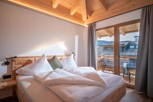 Un dormitorio con una cama con vista a un balcón. en S'Mitterer, en Itter