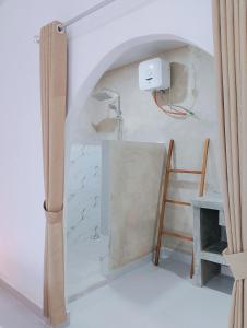 a room with a stone wall and a ladder at My Boo Private House in Sampalan +21 photos