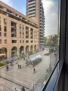 a view from a window of a building with people walking at Nord Gate Avenue Hotel in Aghk'ilisa
