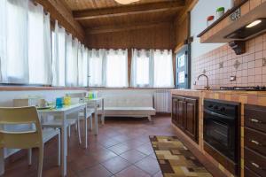 a kitchen with a table and chairs and a couch at Mondello House Eraclea in Mondello