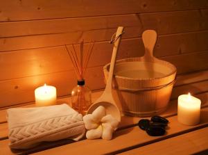 a bathroom counter with candles and towels and a mortar and pestle at Veermaster in Breege