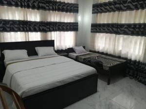 Ένα ή περισσότερα κρεβάτια σε δωμάτιο στο Sunrise Holiday Bungalow