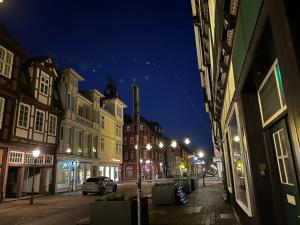 an empty city street at night with buildings at Chez Elly in Celle +10 photos