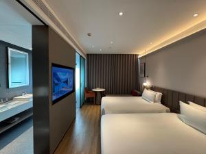 Voodi või voodid majutusasutuse W9-Hotel ShangHai PuDong Airport toas +39 fotot