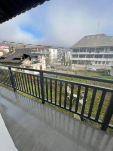 a balcony with a black railing and a building at Apartman 007 in Jajce