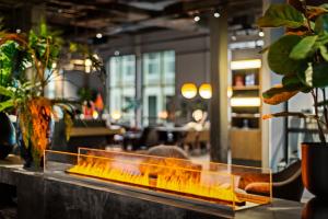 a counter with a fire place in a restaurant at Quality Hotel Ålesund in Ålesund +58 photos