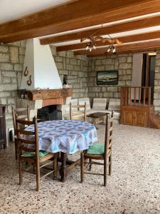 a dining room with a table and chairs and a fireplace at Maison de Charme Vue Exceptionnelle Mer & Montagne in Campomoro