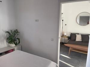 a bedroom with a bed and a couch and a mirror at Bungalow Maspalomas, Jacuzzi in Maspalomas +26 photos