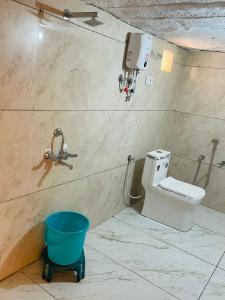 a bathroom with a toilet and a bucket at Mehta Desert camp Sam sand Dunes Jaisalmer in Jāmb