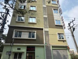 a building with a sign on the side of it at Hotel East park Electronic City in Bengaluru