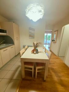 a kitchen with a table with chairs and a light at Spacious N3, quiet,great location in Divonne-les-Bains +6 photos