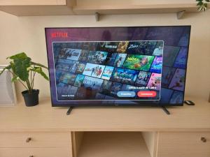 a flat screen tv sitting on top of a table at Spacious N3, quiet,great location in Divonne-les-Bains