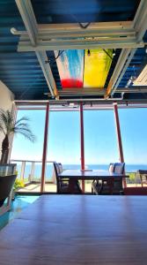 a dining room with a table and a view of the ocean at Hotel KAZENOIRO in Iioka