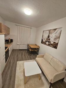 a living room with a couch and a table at Zentrale & gemütliche Wohnung in Wolfsburg in Wolfsburg