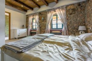 a bedroom with a large bed and two windows at Paun in Bribir +50 photos