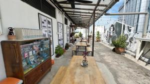 a building with a bench and tables on a street at Cojoy Hotel @ Chinatown in Kuala Lumpur