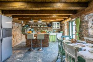 a kitchen with a table and a refrigerator at Paun in Bribir
