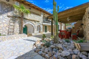 a house with a patio with a cactus at Paun in Bribir