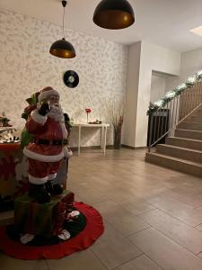 a statue of a santa in a room with stairs at Pensiunea Carmen - Bikers Friendly Nest in Sibiu