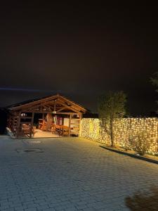 a building with a pavilion with a fence at night at Pensiunea Carmen - Bikers Friendly Nest in Sibiu