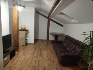 a living room with a couch and a tv at ANNA Home in Craiova