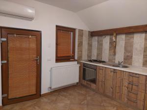 a kitchen with a sink and a stove at ANNA Home in Craiova