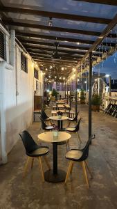 a row of tables and chairs in a patio at Cojoy Hotel @ Chinatown in Kuala Lumpur