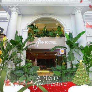 a store front with a sign for a merry joy festival at Joi Boutique Bãi Trước in Vung Tau