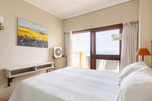 a bedroom with a white bed and a window at Primera línea de playa Marbella in Marbella +28 photos
