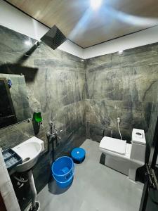 a bathroom with a sink and a toilet at Shri omkarnath Guest house Ayodhya in Ayodhya