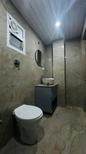 a bathroom with a toilet and a sink at The Catel Hotel 