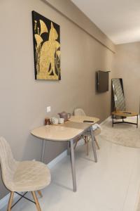 a room with a table and chairs and a tv at Аренда квартиры #19 NRG U-Tower Rent an apartment in Tashkent +36 photos