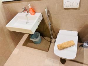 a bathroom with a white sink and a toilet at Lucentia Residence by Infinity swimming pool,lalaport KL in Kuala Lumpur +84 photos